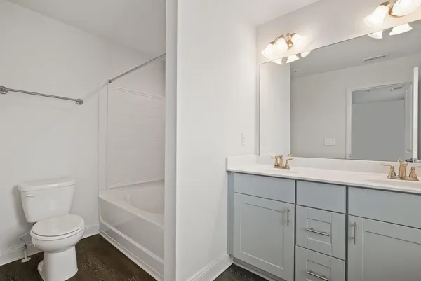 an empty room with windows and a ceiling fan