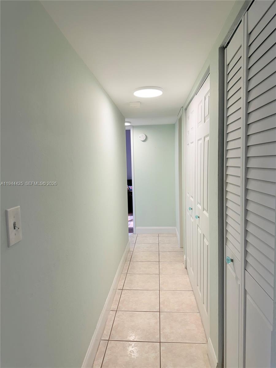 8951 North New River Canal Road, Unit 2D Plantation, FL 33324 - Photo 12 of 30 a view of hallway with a window and a mirror