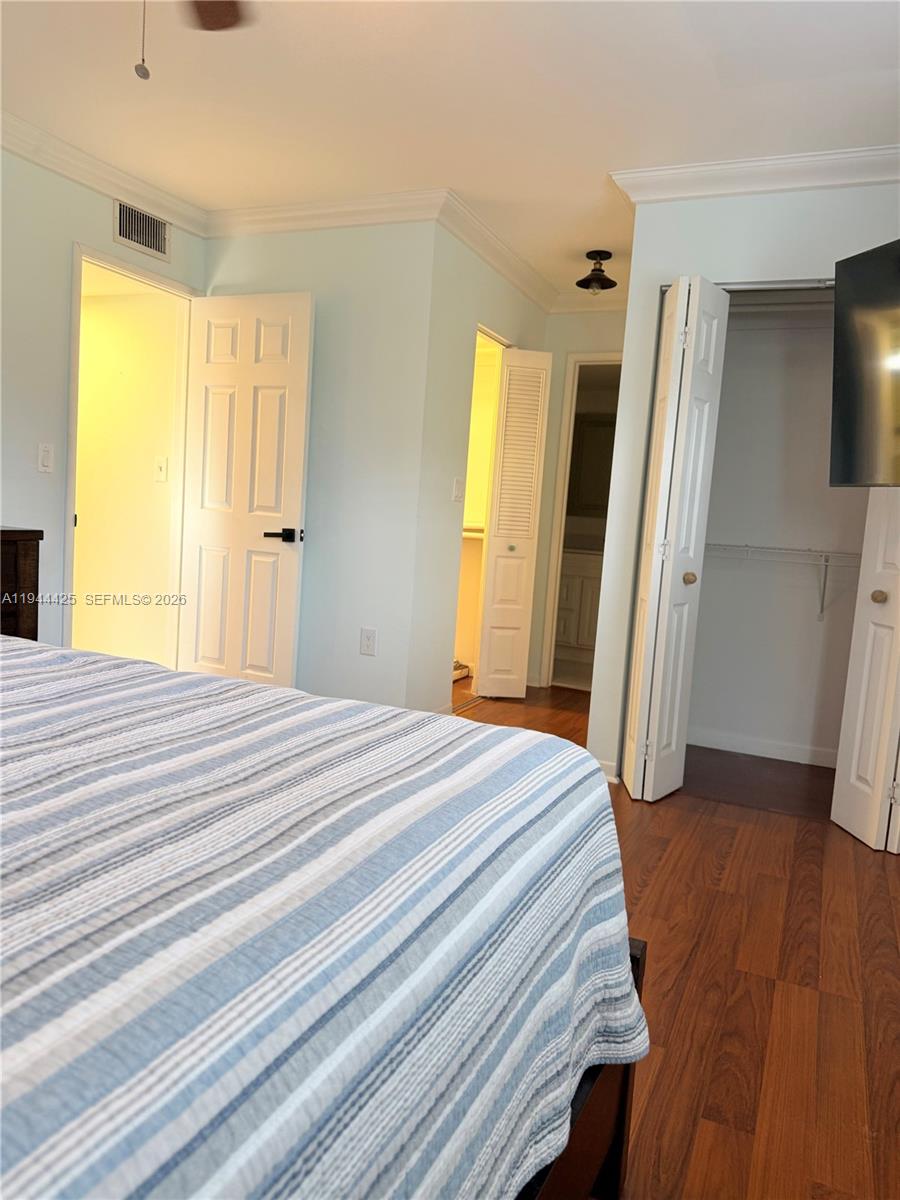 8951 North New River Canal Road, Unit 2D Plantation, FL 33324 - Photo 21 of 30 a bedroom with a bed and a dresser