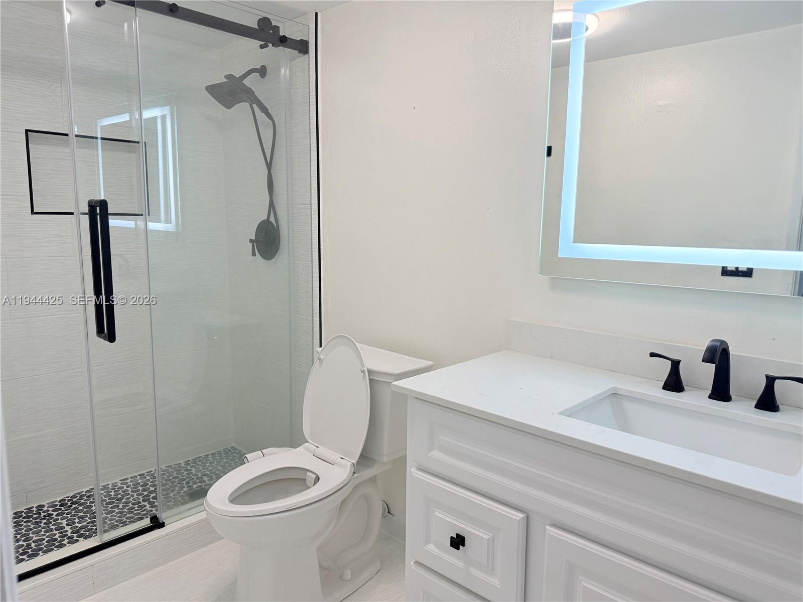 8951 North New River Canal Road, Unit 2D Plantation, FL 33324 - Photo 24 of 30 a bathroom with a sink toilet and shower