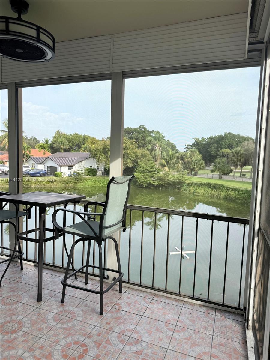 8951 North New River Canal Road, Unit 2D Plantation, FL 33324 - Photo 28 of 30 a view of a chairs and table in patio