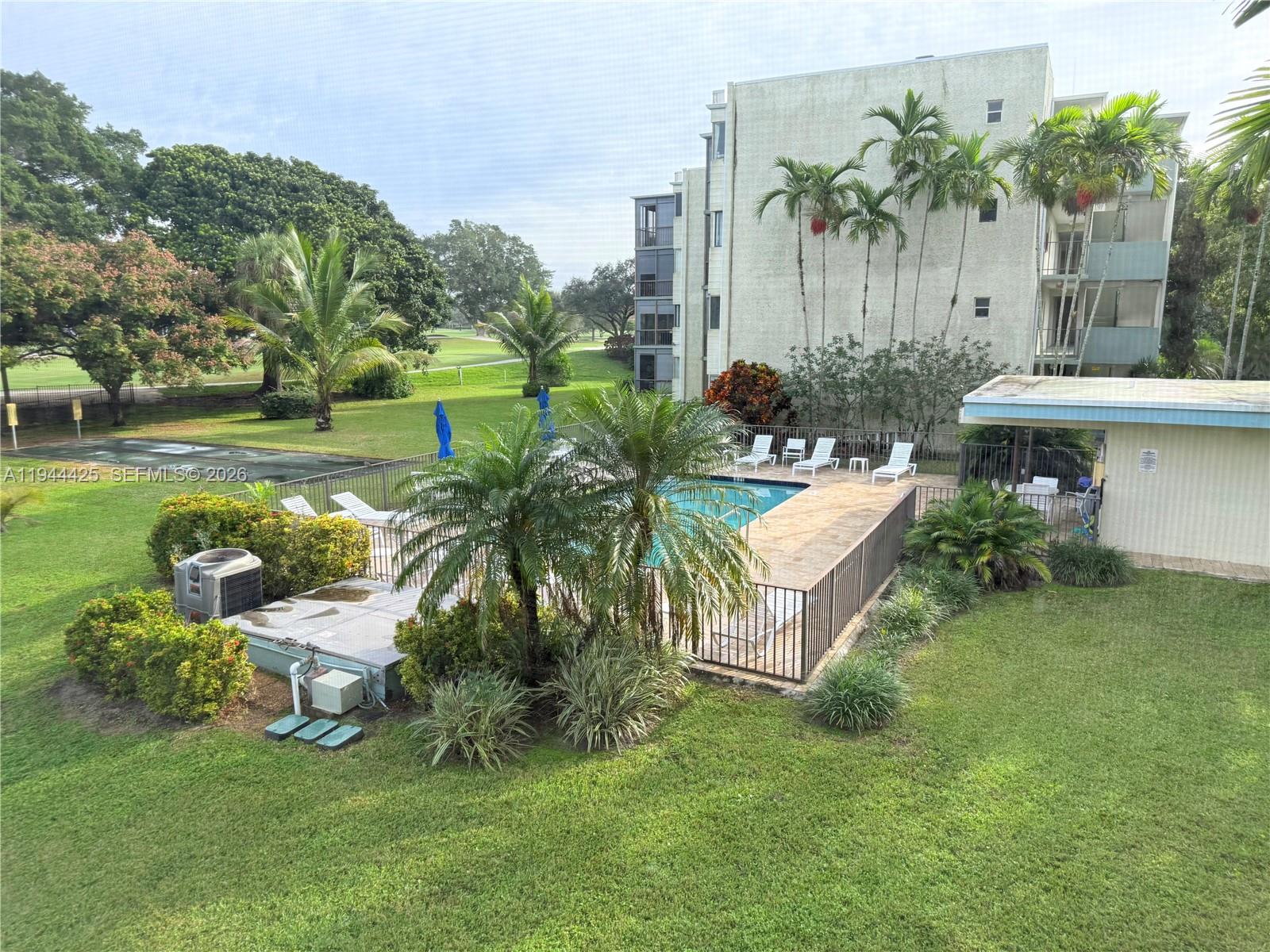 8951 North New River Canal Road, Unit 2D Plantation, FL 33324 - Photo 29 of 30 a backyard of a house with table and chairs