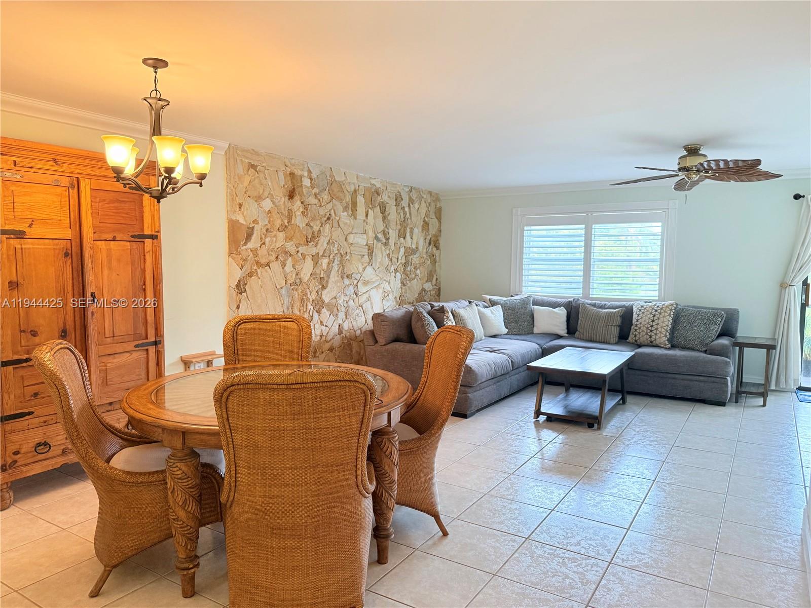 8951 North New River Canal Road, Unit 2D Plantation, FL 33324 - Photo 6 of 30 a living room with furniture and a chandelier