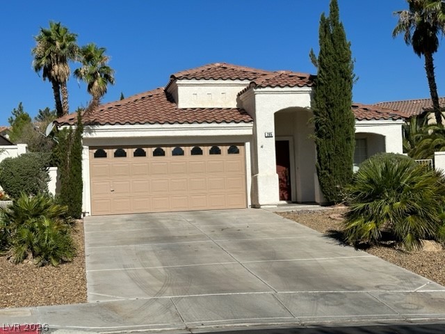 285 Spring Palms Street Henderson, NV 89012 - Photo 2 of 38 Mediterranean / spanish-style house with concrete driveway, an attached garage, a tile roof, and stucco siding