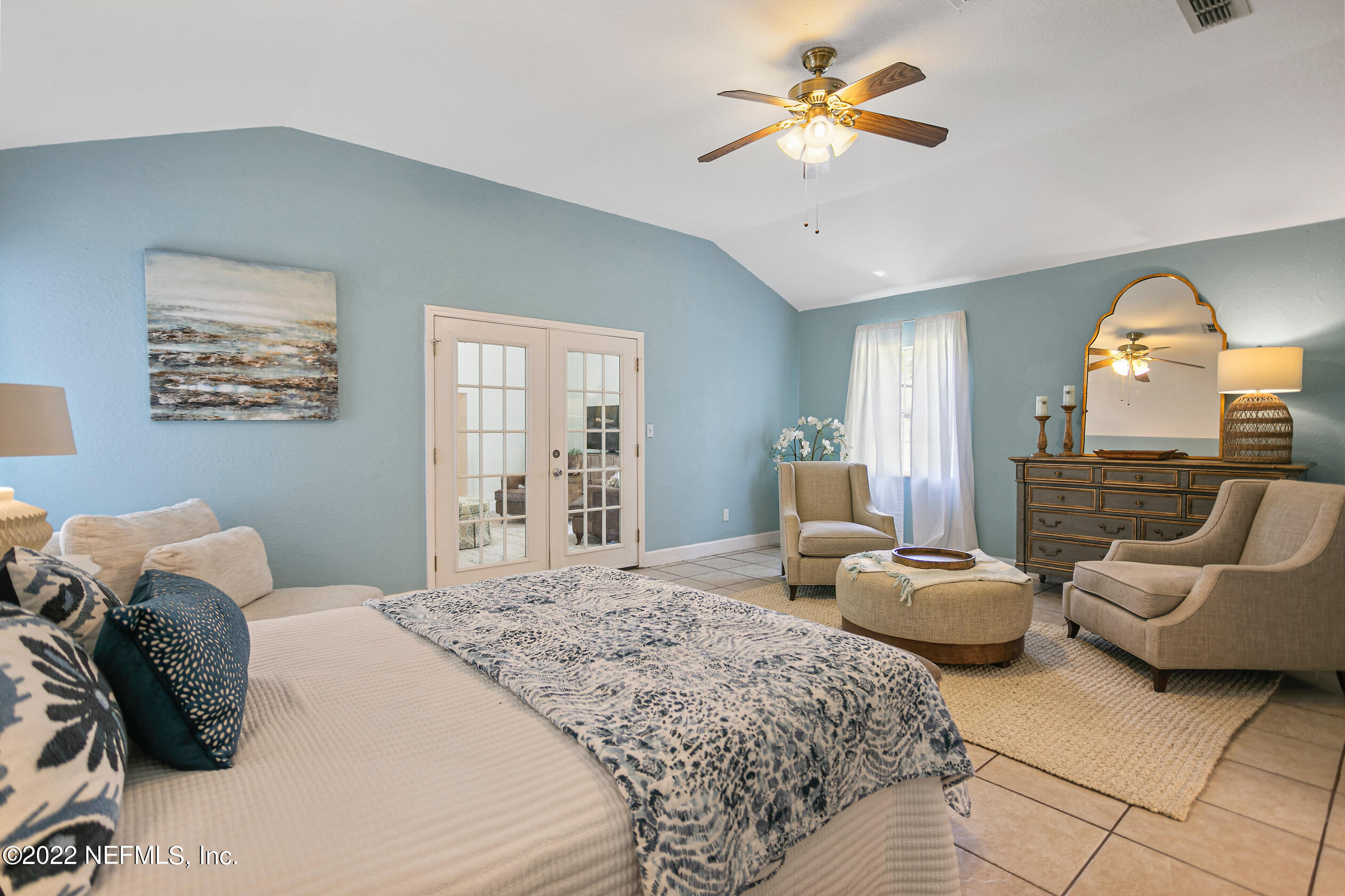 4631 Tanbark Road Jacksonville, FL 32210 - Photo 13 of 27 a bedroom with a bed and a chandelier