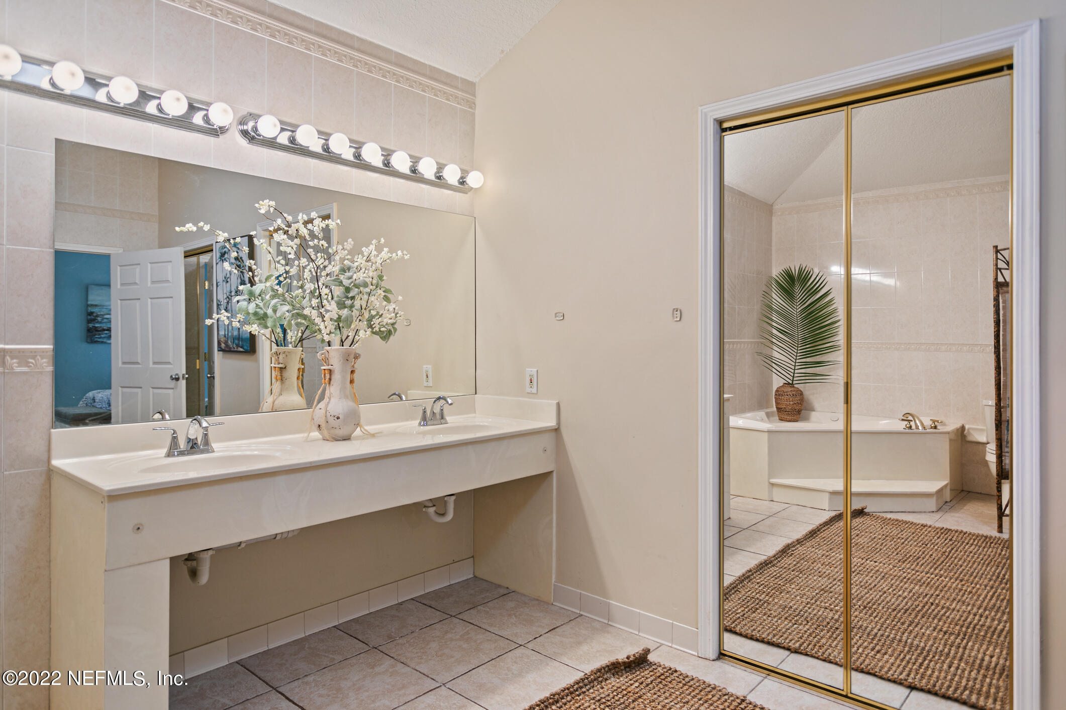 4631 Tanbark Road Jacksonville, FL 32210 - Photo 18 of 27 a en suite bathroom with a double vanity sink and a mirror