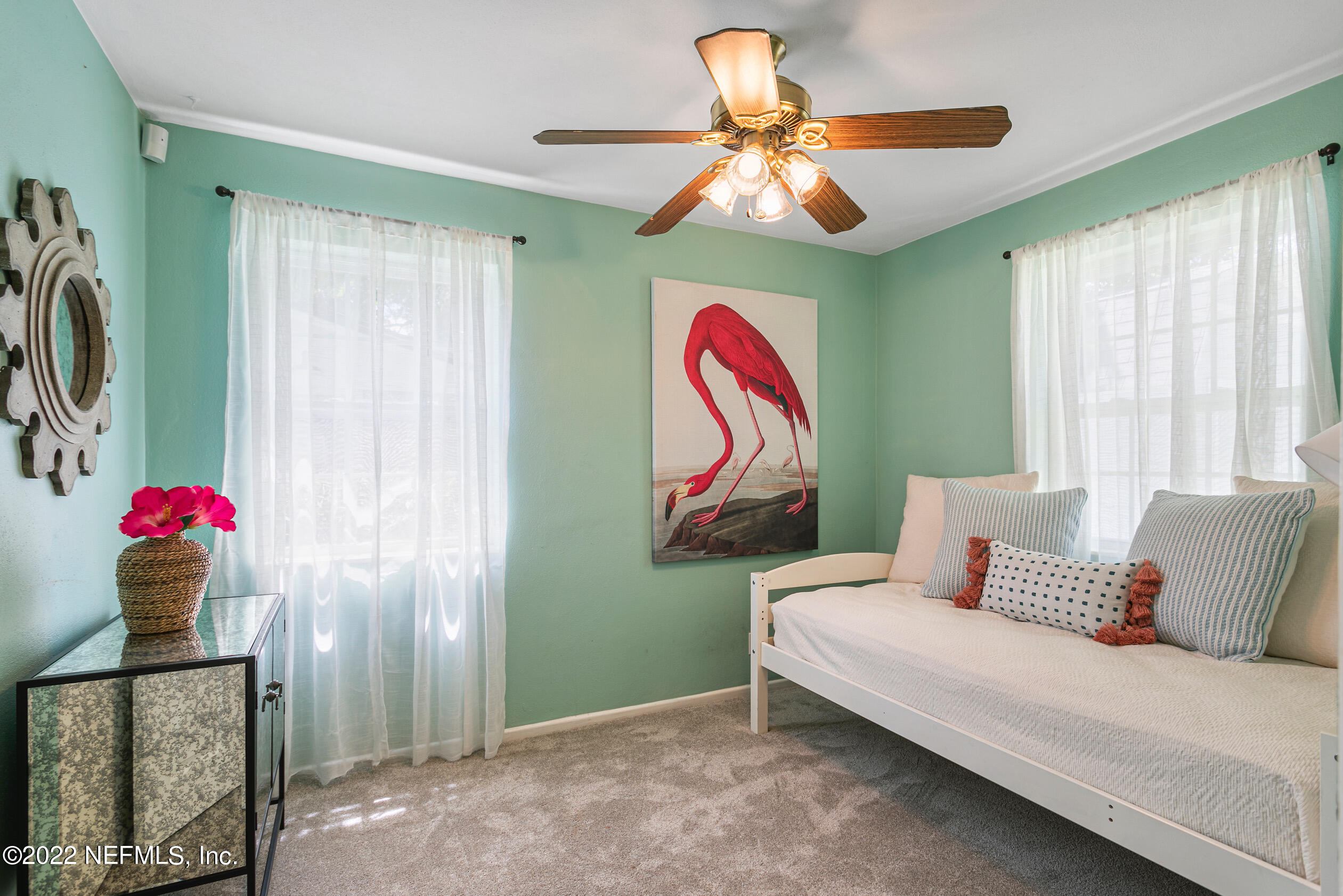 4631 Tanbark Road Jacksonville, FL 32210 - Photo 19 of 27 a bedroom with a bed and a chandelier