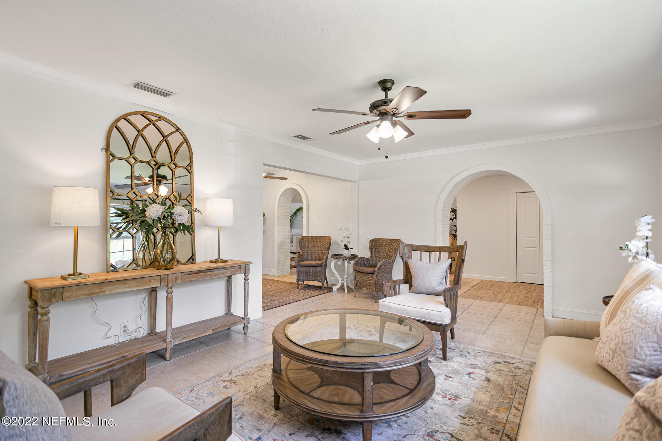 4631 Tanbark Road Jacksonville, FL 32210 - Photo 2 of 27 a living room with furniture a chandelier and a large window
