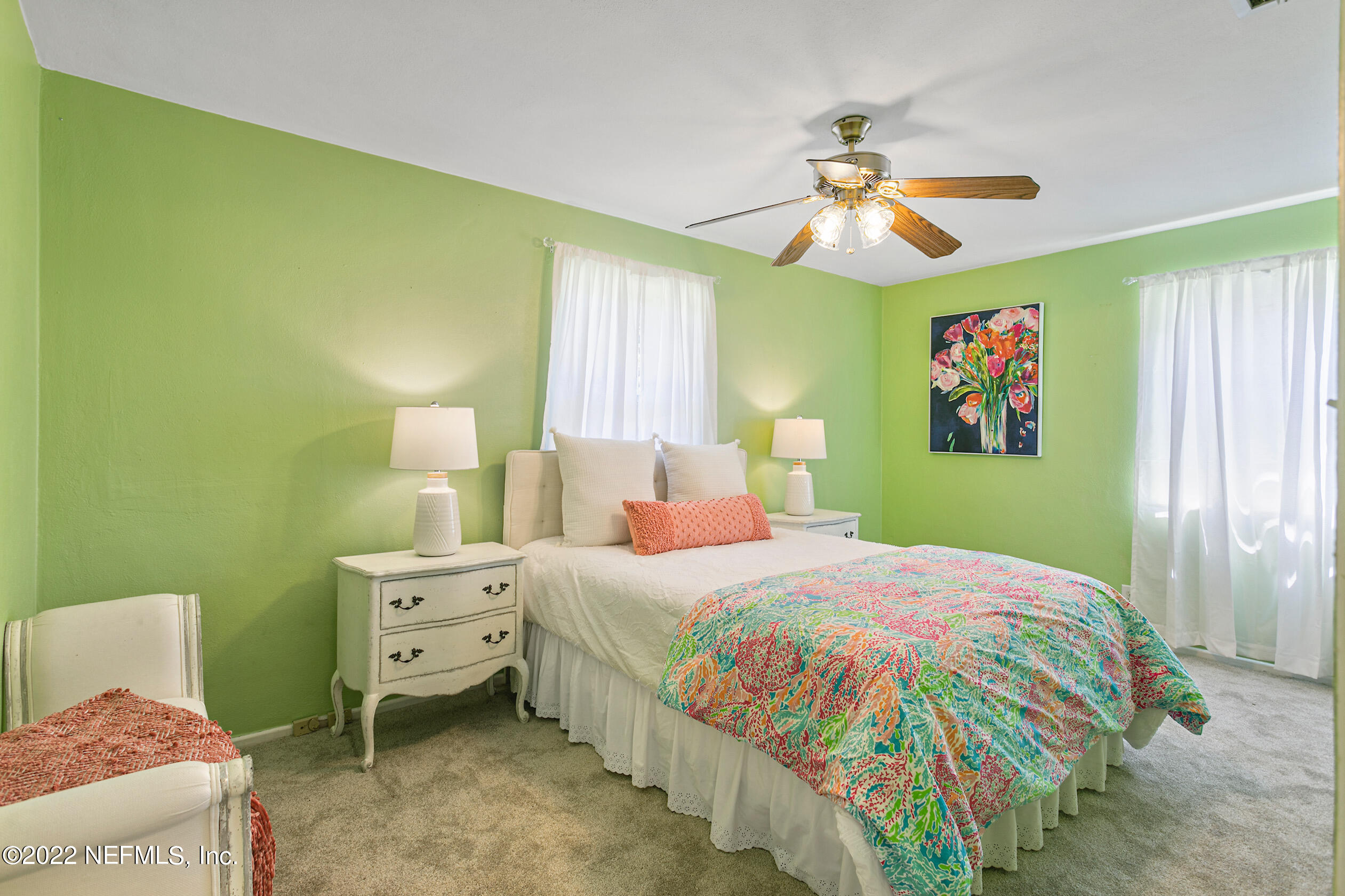 4631 Tanbark Road Jacksonville, FL 32210 - Photo 21 of 27 a bedroom with a bed and a chandelier