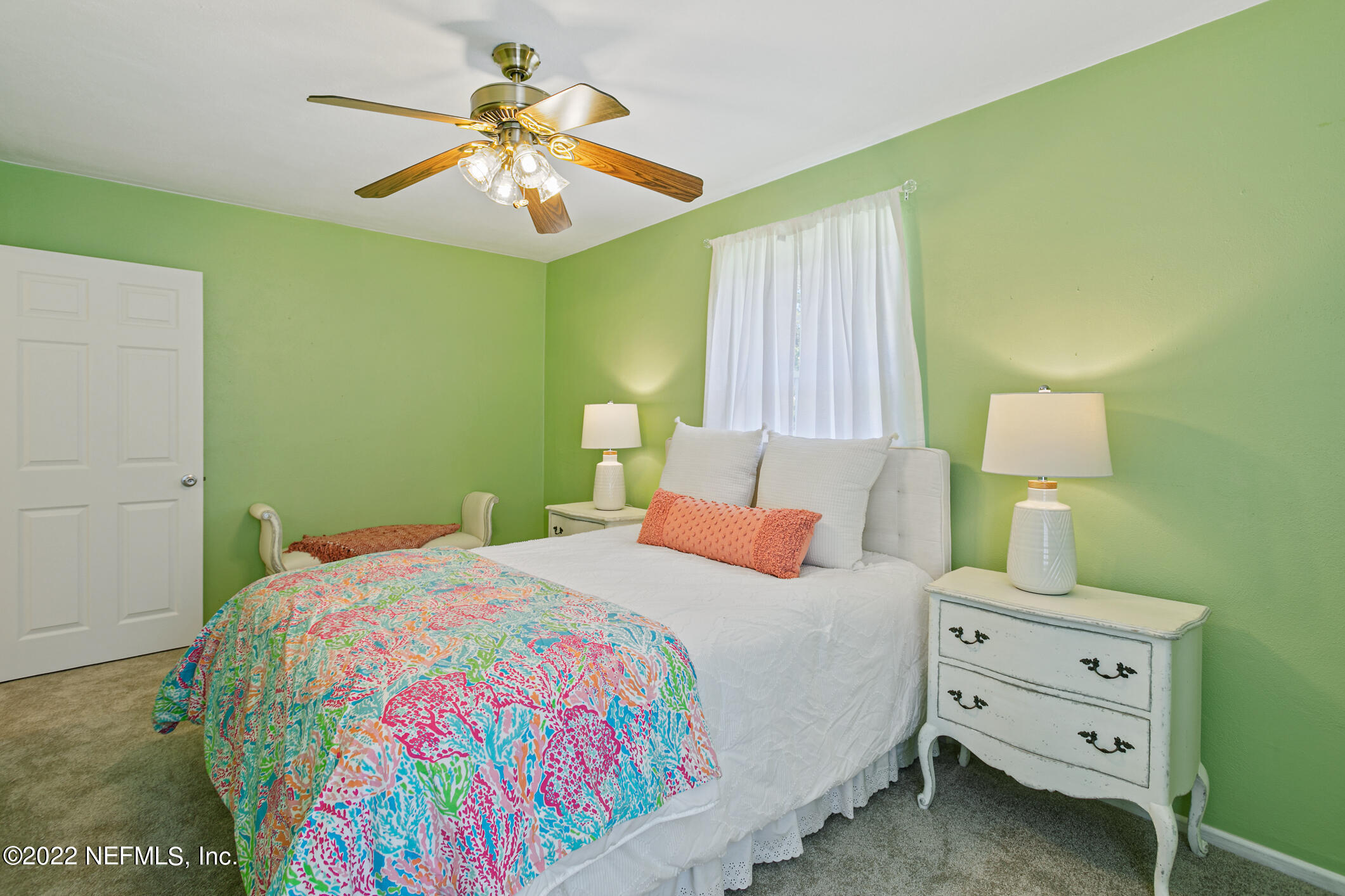 4631 Tanbark Road Jacksonville, FL 32210 - Photo 22 of 27 a bedroom with a bed and a chandelier