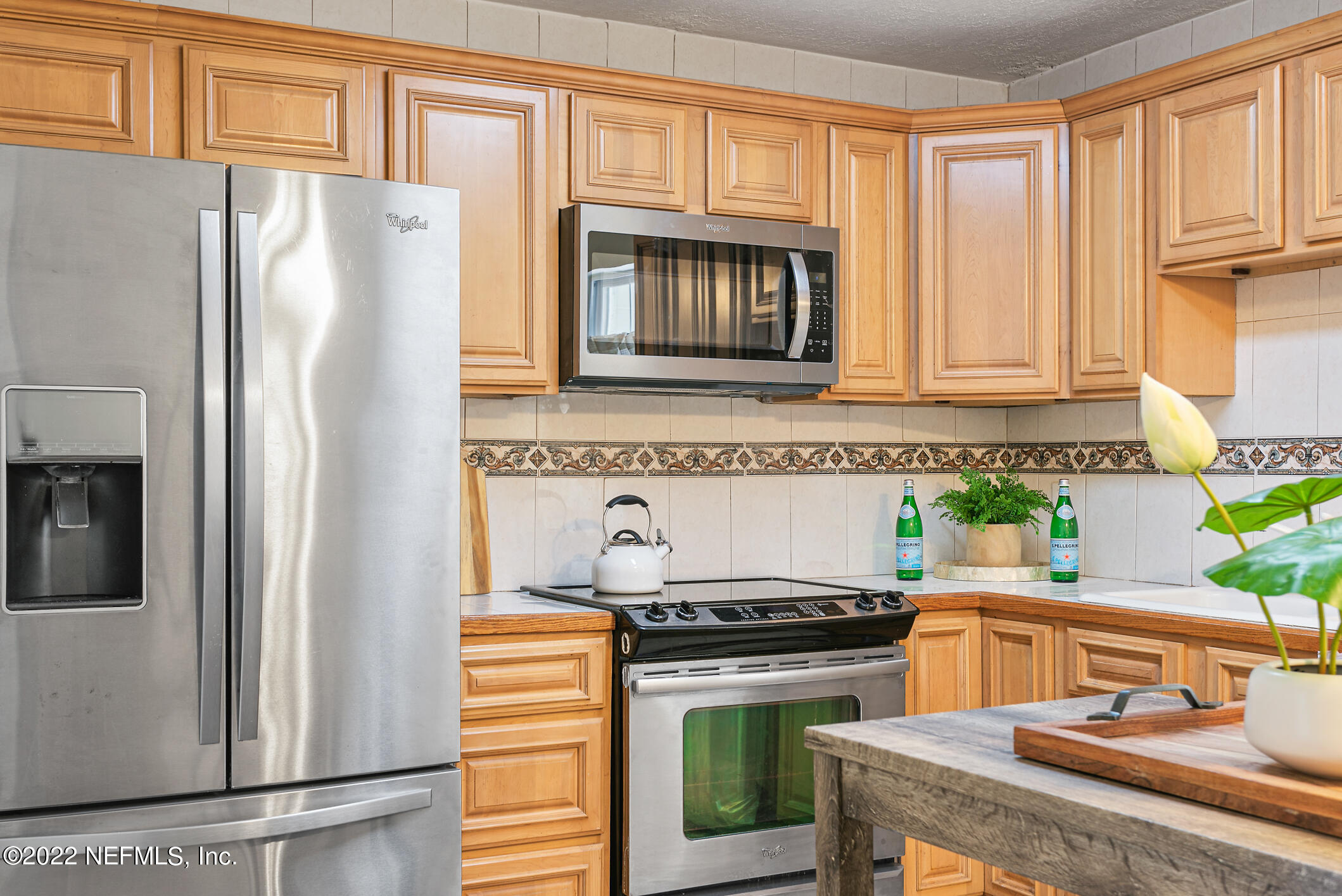 4631 Tanbark Road Jacksonville, FL 32210 - Photo 6 of 27 a kitchen with granite countertop a refrigerator and a stove