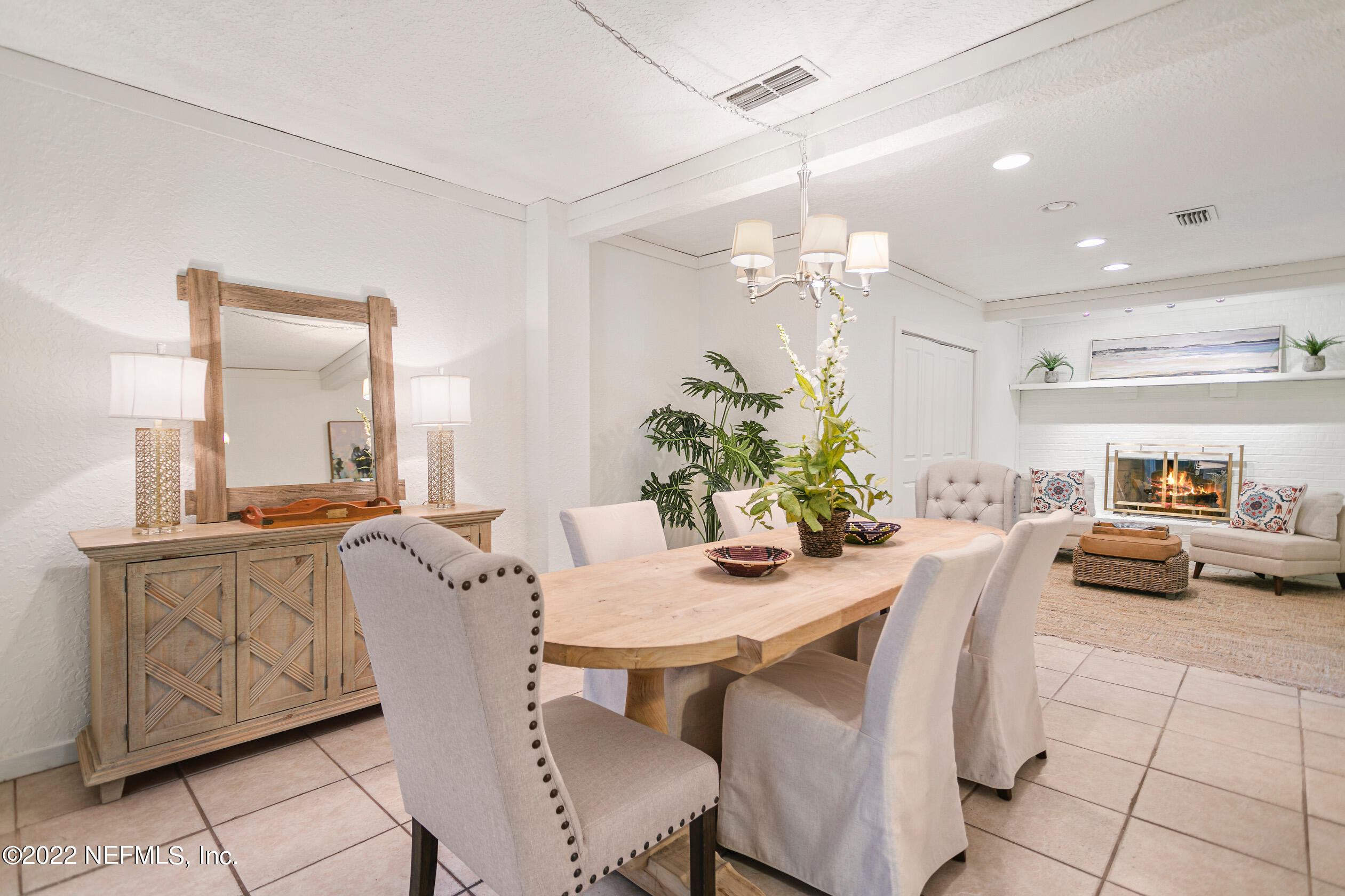 4631 Tanbark Road Jacksonville, FL 32210 - Photo 8 of 27 a view of a dining room with furniture and a chandelier