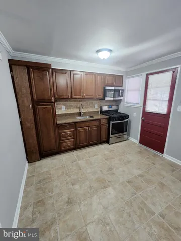 a large kitchen with cabinets and steel stainless steel appliances