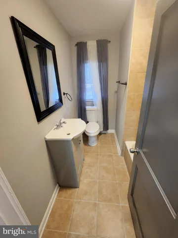 a bathroom with a sink a mirror and tub
