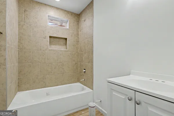 a bathroom with a bathtub and a shower