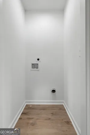 an empty room with a window and a ceiling fan