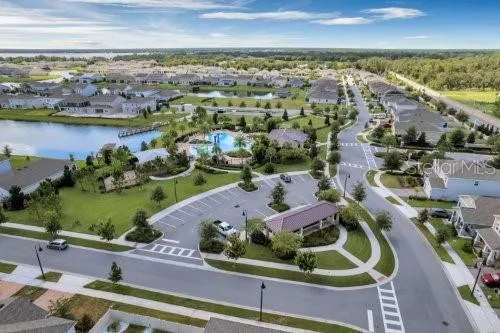 an aerial view of lake and residential houses with outdoor space