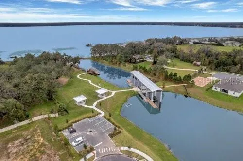 an aerial view of a house with swimming pool and outdoor seating