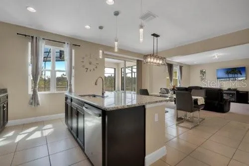 a kitchen with stainless steel appliances granite countertop a sink counter space and a window