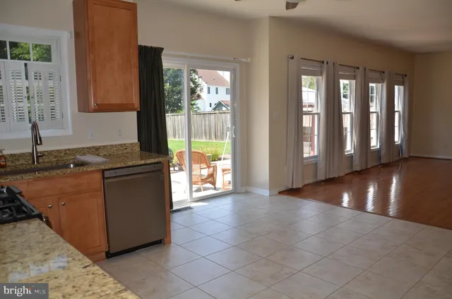 a kitchen with granite countertop a stove a sink and a granite counter tops