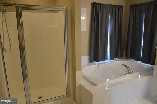 a bathroom with a granite countertop sink and shower