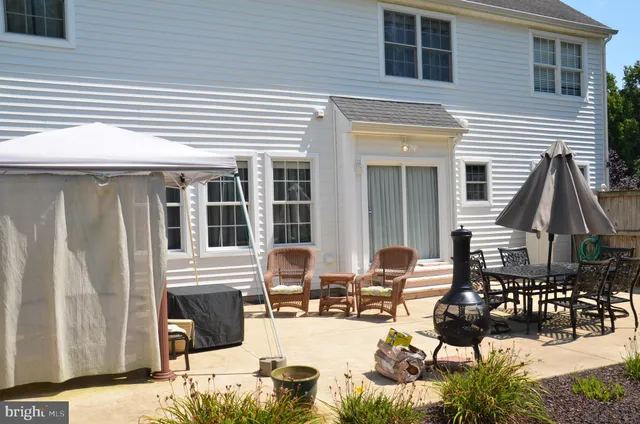a view of a patio with couches table and chairs and potted plants