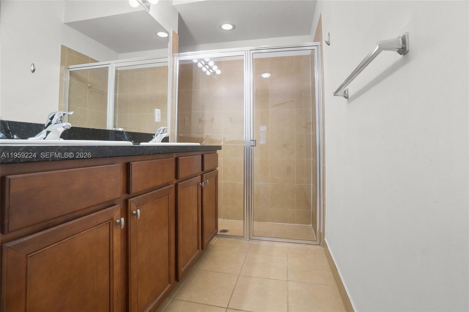 14774 Southwest 10th Street, Unit 10502 Pembroke Pines, FL 33027 - Photo 22 of 42 a bathroom with a glass door shower a sink and a mirror