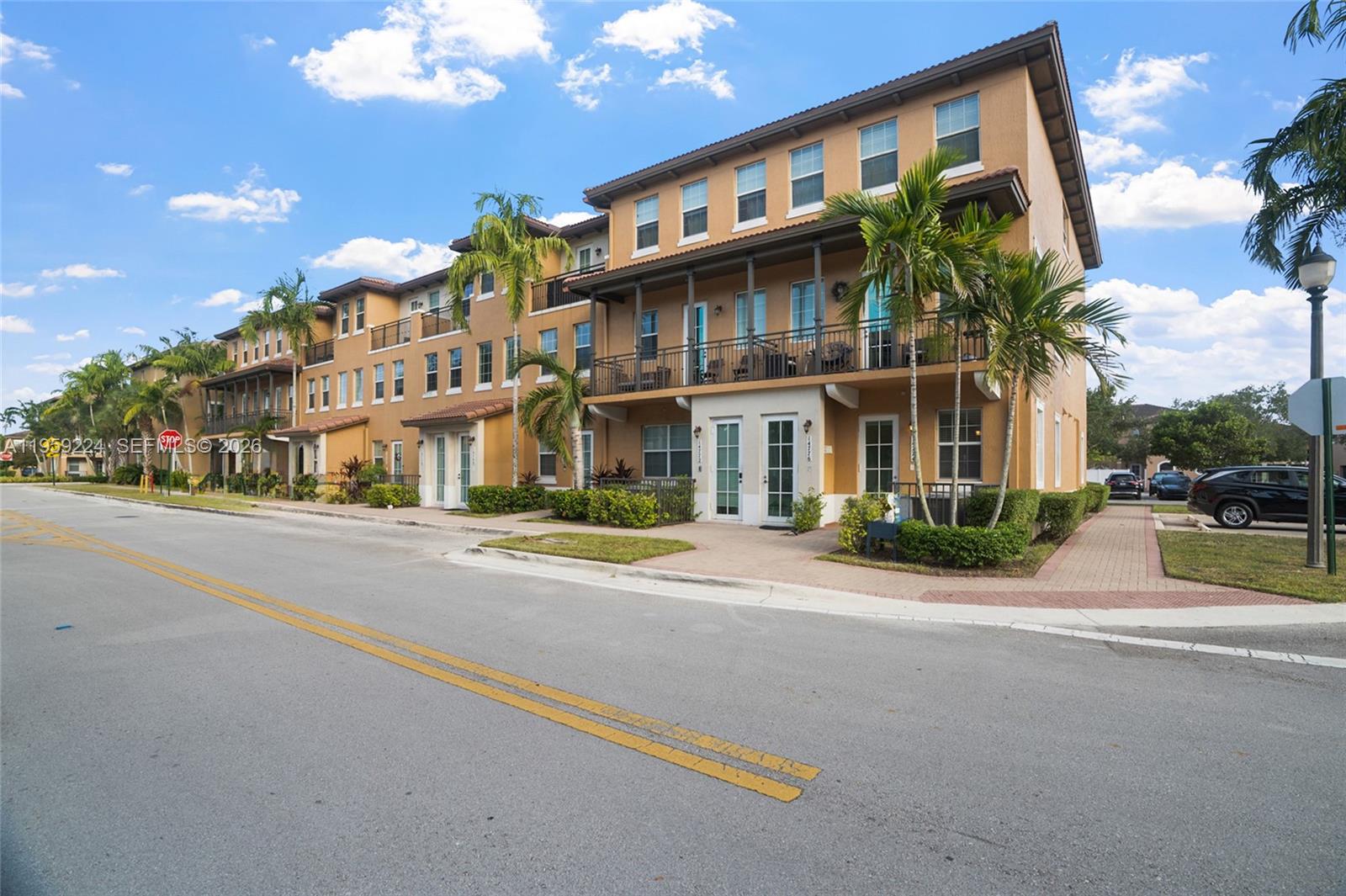 14774 Southwest 10th Street, Unit 10502 Pembroke Pines, FL 33027 - Photo 3 of 42 a front view of a building with street view and trees