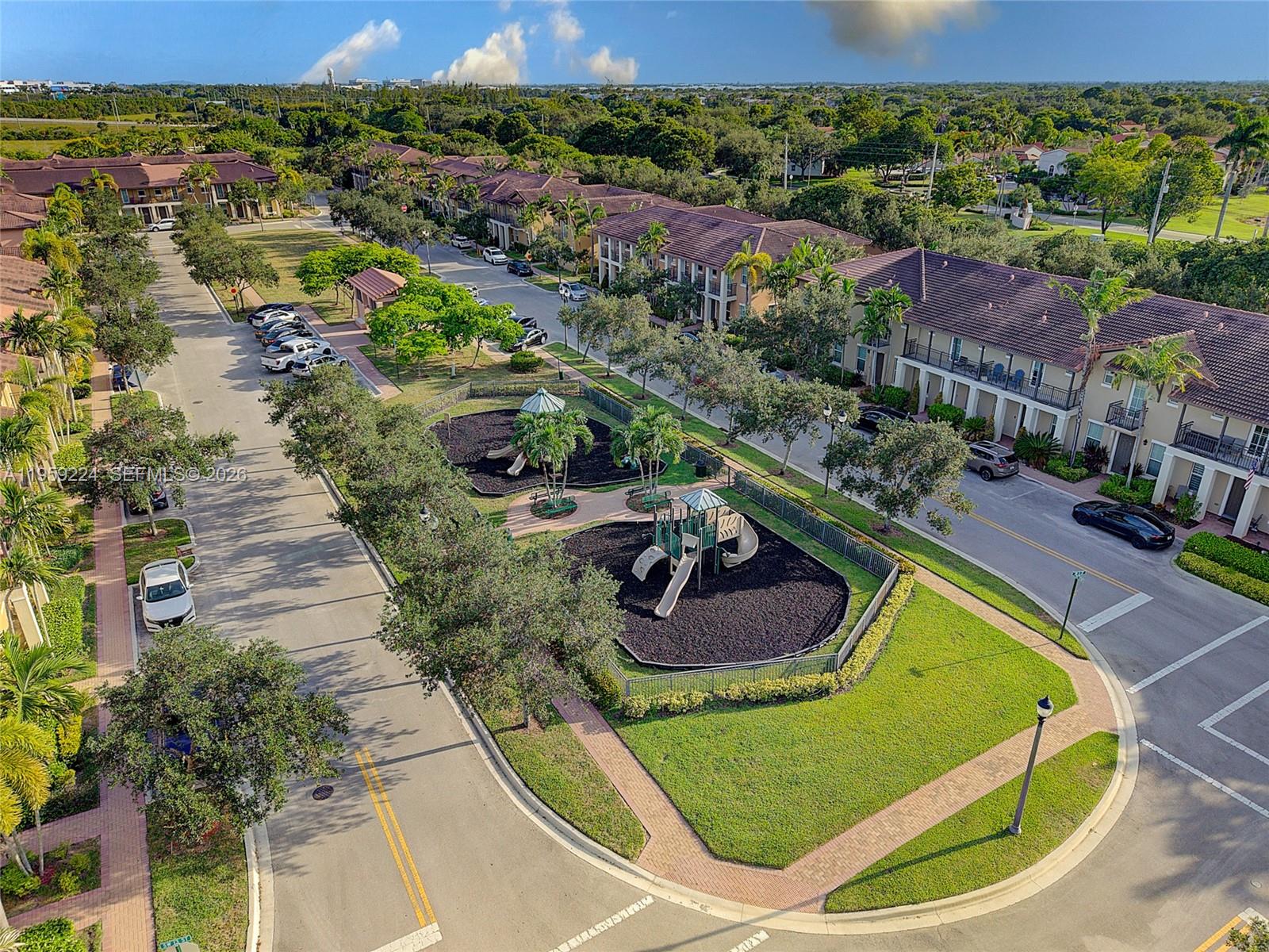 14774 Southwest 10th Street, Unit 10502 Pembroke Pines, FL 33027 - Photo 35 of 42 a swimming pool with some trees in the background