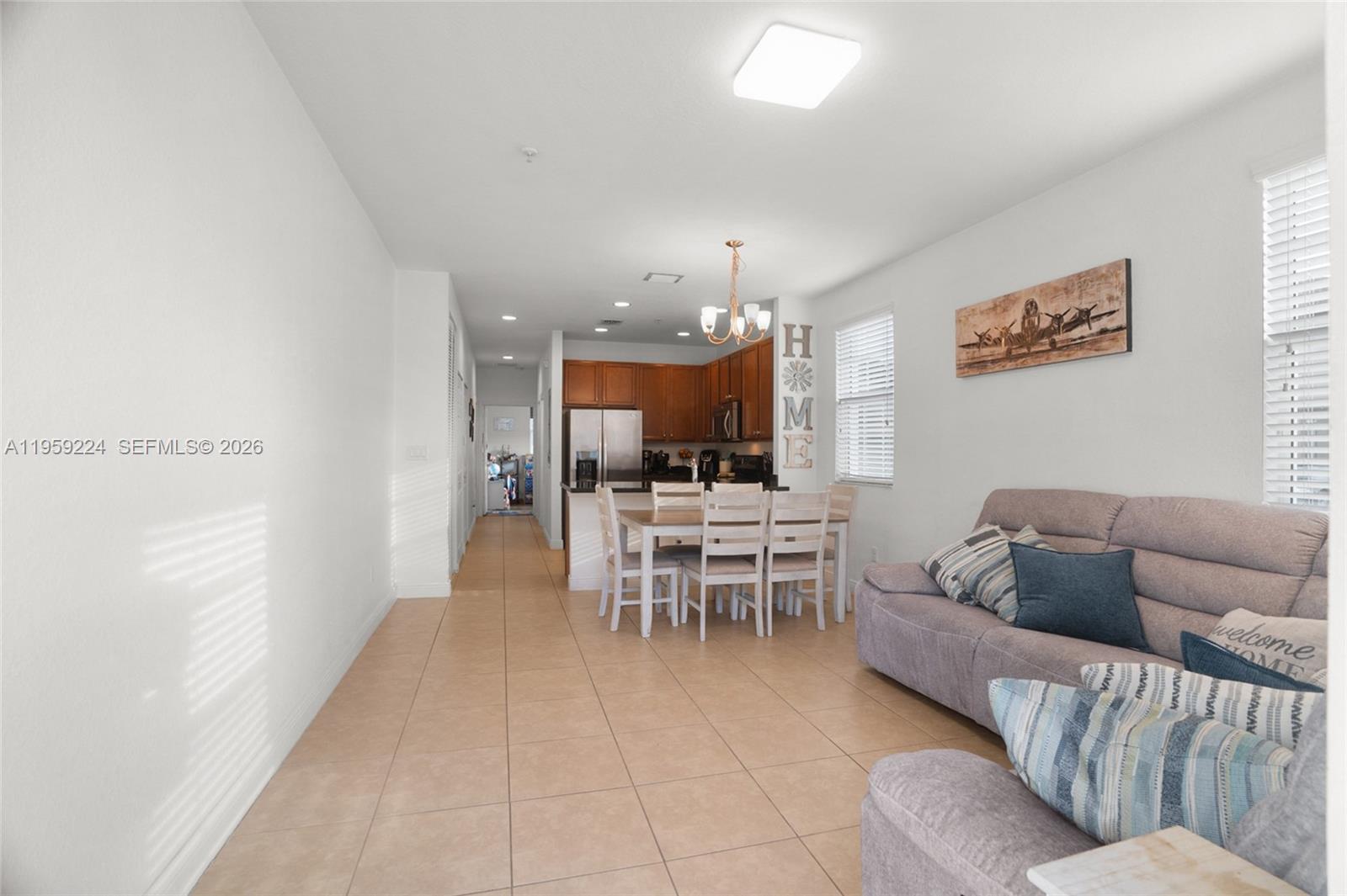 14774 Southwest 10th Street, Unit 10502 Pembroke Pines, FL 33027 - Photo 6 of 42 a living room with furniture and a dining room