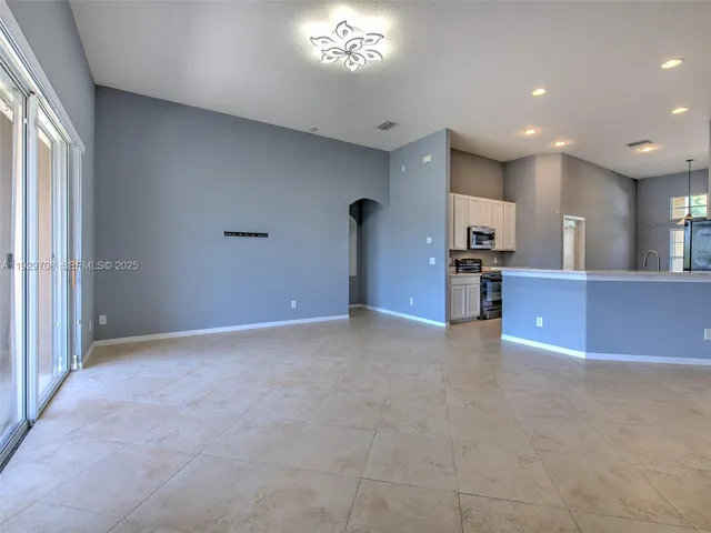a view of a kitchen with a sink and a large window