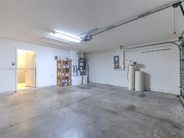 an aerial view of a house with a yard and lake view