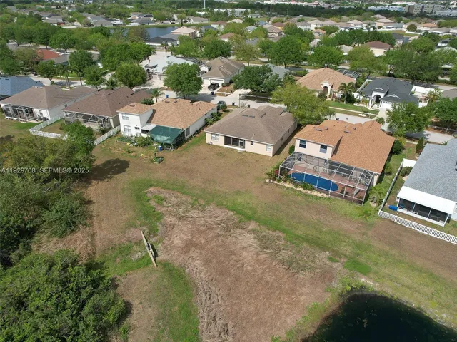 an aerial view of a house with outdoor space and lake view