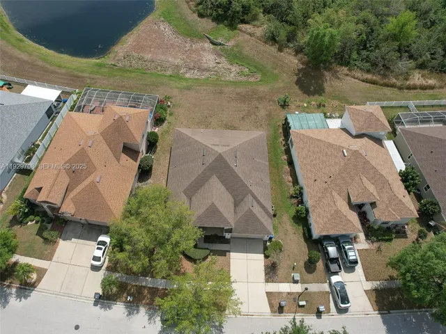 an aerial view of residential houses with outdoor space