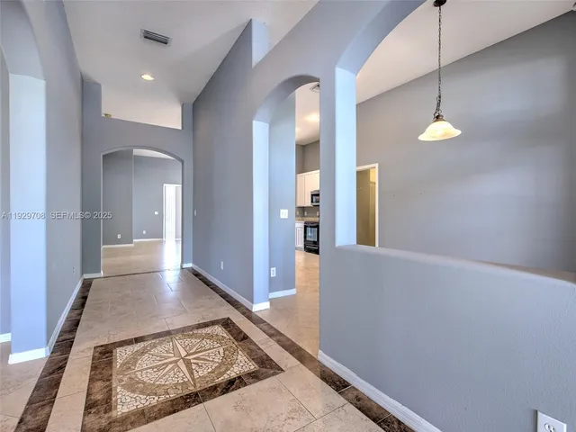 a view of a hallway with furniture