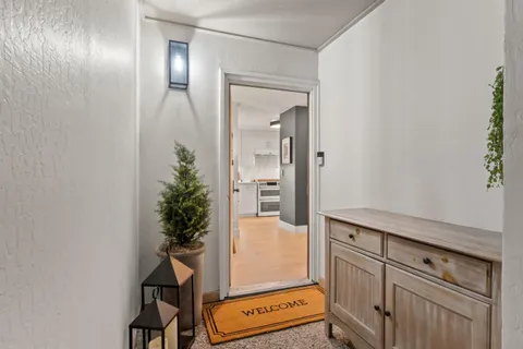 a view of an entryway with wooden floor