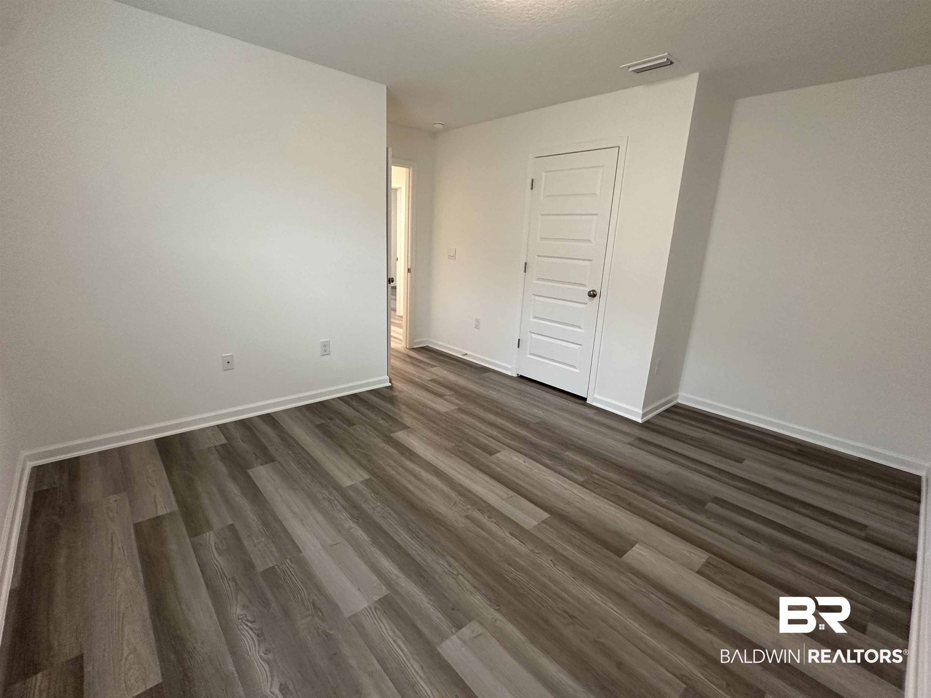 22275 Aleutian Avenue Foley, AL 36535 - Photo 24 of 72 Unfurnished room with dark hardwood / wood-style floors