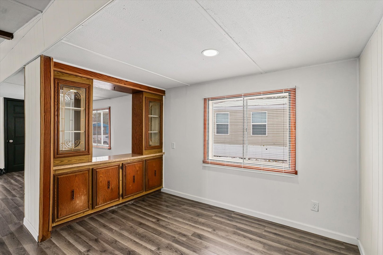1221 Brookshire Drive, Unit 1221 Rantoul, IL 61866 - Photo 12 of 30 an empty room with wooden floor and windows