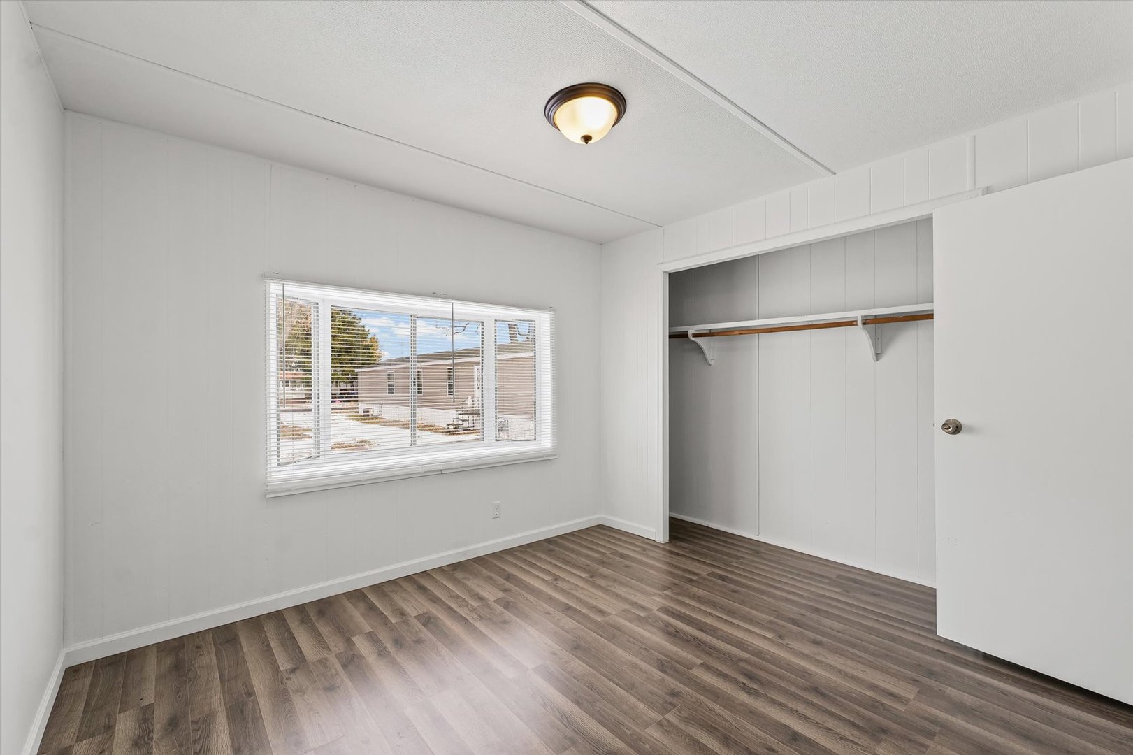 1221 Brookshire Drive, Unit 1221 Rantoul, IL 61866 - Photo 20 of 30 a view of an empty room with wooden floor and a window