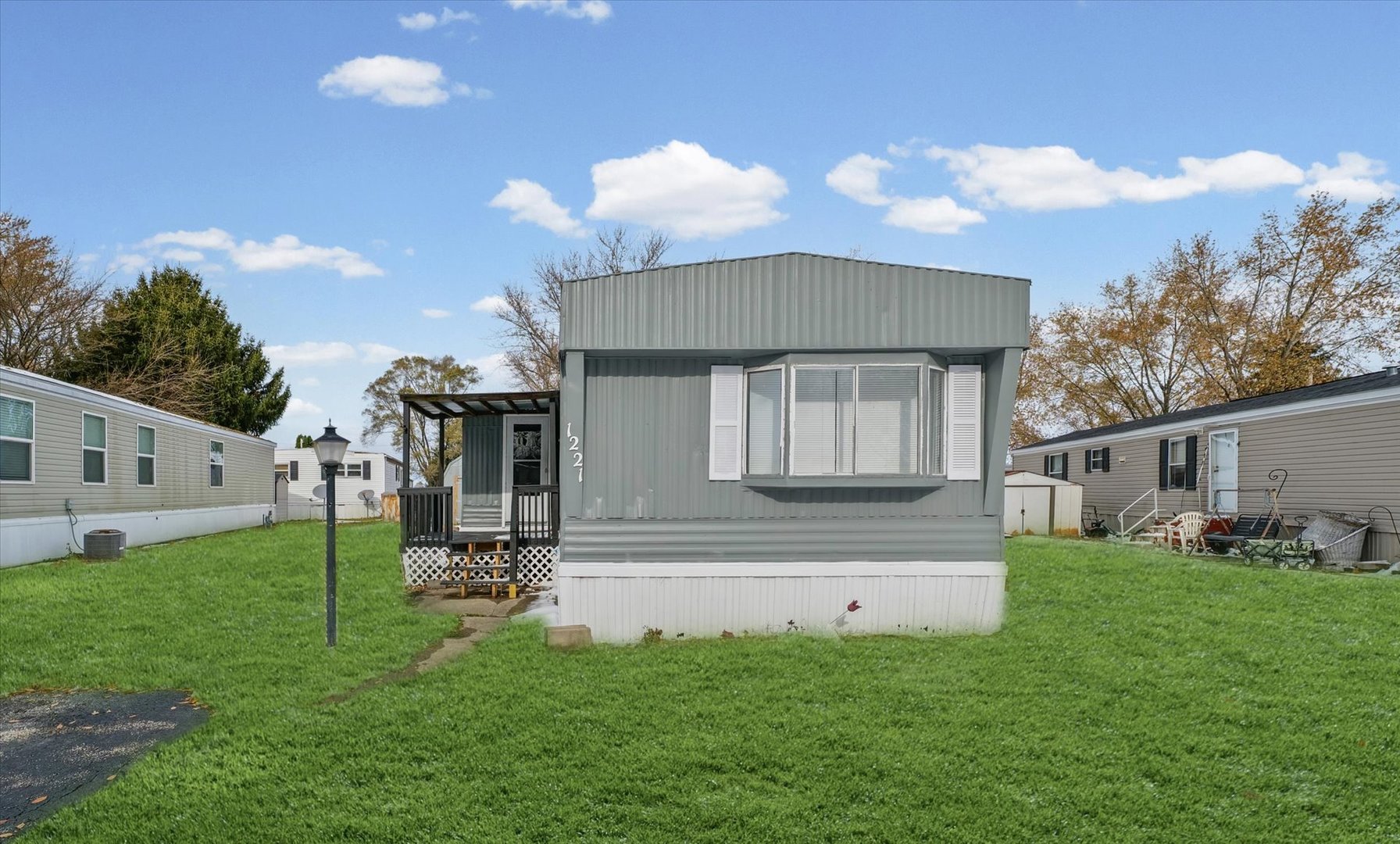 1221 Brookshire Drive, Unit 1221 Rantoul, IL 61866 - Photo 2 of 30 a front view of a house with a yard and outdoor seating
