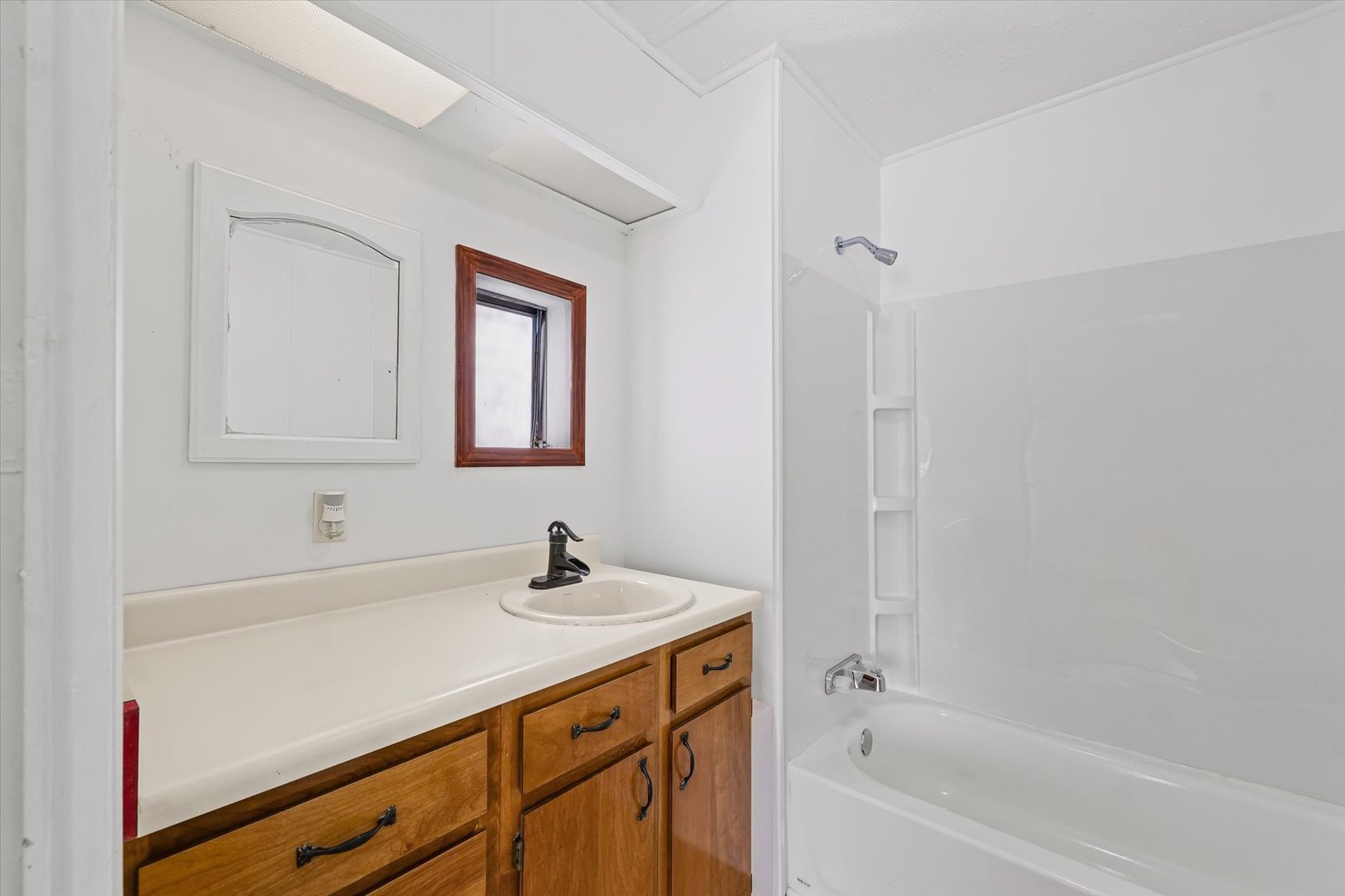 1221 Brookshire Drive, Unit 1221 Rantoul, IL 61866 - Photo 22 of 30 a bathroom with a bathtub sink and mirror