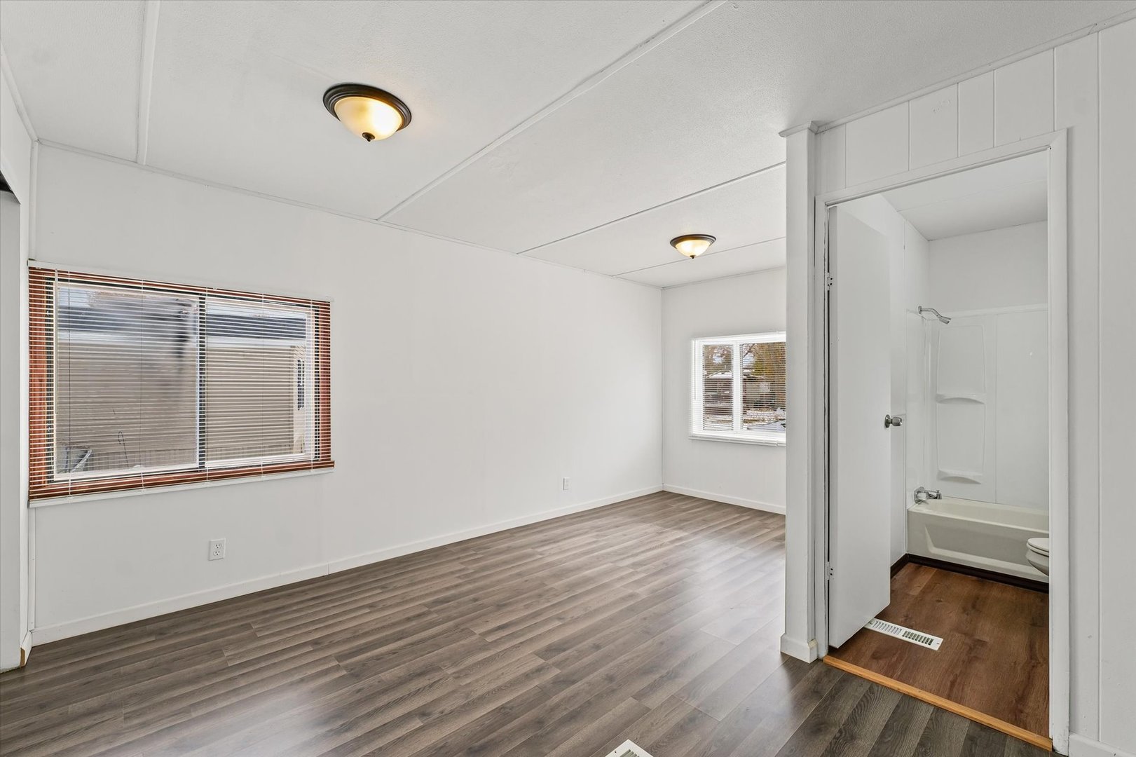 1221 Brookshire Drive, Unit 1221 Rantoul, IL 61866 - Photo 23 of 30 an empty room with wooden floor and windows