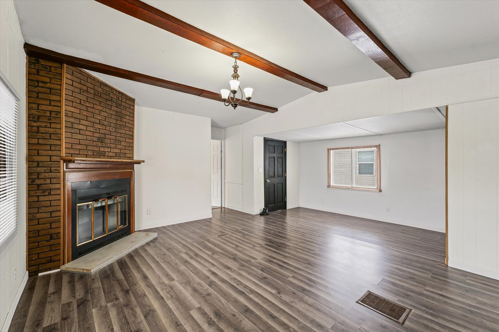 1221 Brookshire Drive, Unit 1221 Rantoul, IL 61866 - Photo 9 of 30 a view of empty room with wooden floor and fireplace