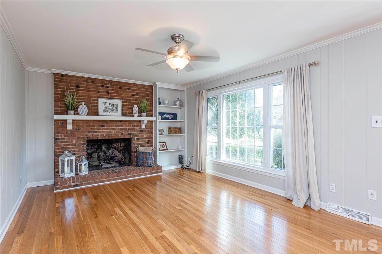 5708 Partridge Lane Raleigh, NC 27609 - Photo 3 of 27 a view of an empty room with wooden floor fireplace and a window