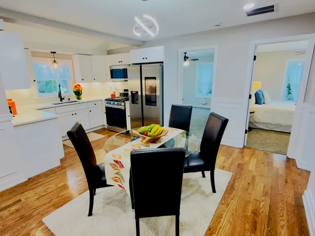 a view of a dining room with furniture and wooden floor