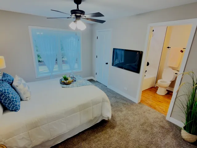 a bedroom with a bed and a flat screen tv