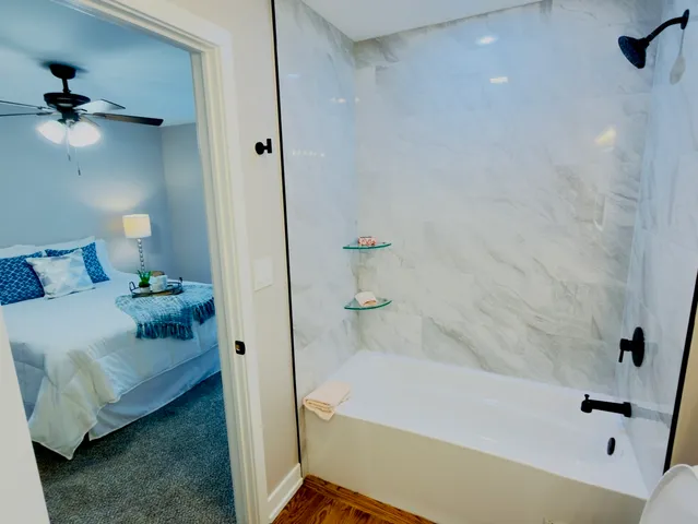 a bathroom with a bathtub and a shower