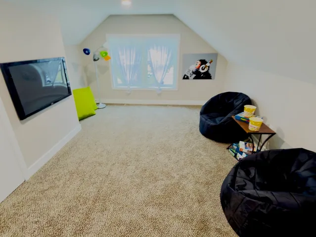 a living room with furniture and a mirror