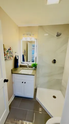 a bathroom with a double vanity sink a mirror and a bathtub