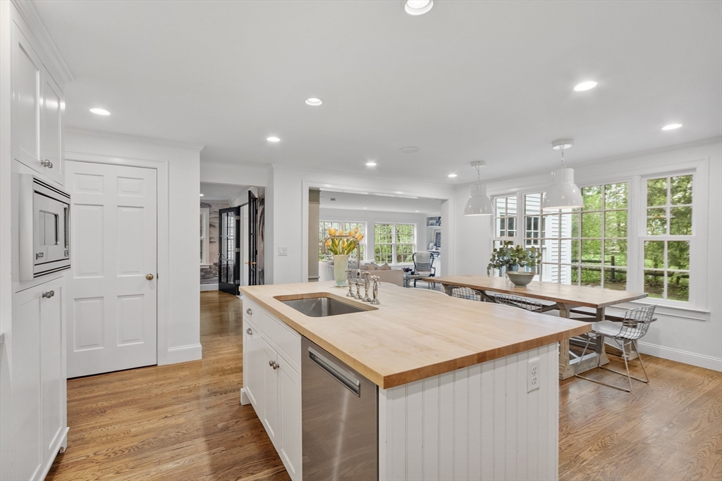 90 Coolidge Road Concord, MA 01742 - Photo 11 of 42 a view of a kitchen counter top space a sink a refrigerator and window